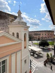 a white building with a cross on top of it at Le Muse Loft in Caserta