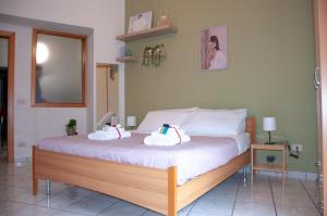 a bedroom with a bed with two towels on it at Le Muse Loft in Caserta