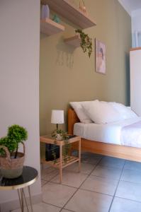 a bedroom with a bed and a table with a lamp at Le Muse Loft in Caserta