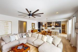 a living room with a couch and a ceiling fan at Blue Skies Over Butler Creek in Belgrade