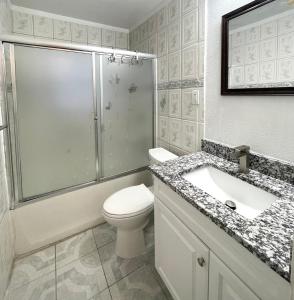 a bathroom with a shower and a toilet and a sink at Room near downtown Dallas4 in Dallas