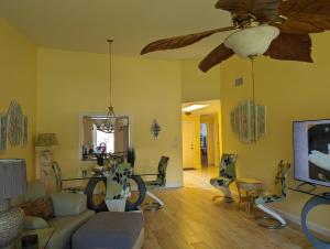 a living room with a couch and a ceiling fan at LUX VILLAs on beautiful Palmer Ranch in Vamo