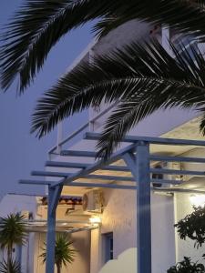 a stairway leading up to a building with palm trees at Bellevue Village ''Αdults Only'' in Agia Pelagia