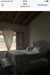 a bedroom with a large bed and a window at Las yucas in Mercedes