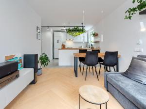 a living room with a couch and a table at Seaside Retreat Gdańsk - 64m2, Parking, Workspace- by Rentujemy in Gdańsk