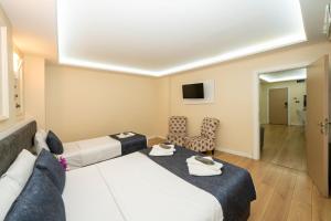 a hotel room with two beds and a tv at Luce Suites Taksim in Istanbul