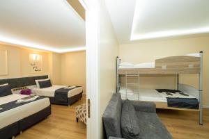 a room with two bunk beds and a couch at Luce Suites Taksim in Istanbul