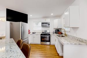 a kitchen with white cabinets and a counter top at Orange Street Haven in Wilmington
