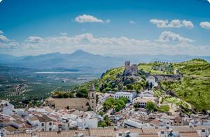 a city with a castle on top of a hill at Casa Cruz de Marbella Luque in Luque
