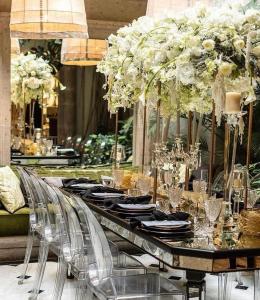 a long table with chairs and flowers on it at Nima Local House Hotel & Spa in Mexico City