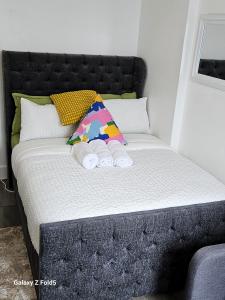 a bed with two towels on top of it at LONDON SLEEPHOUSE in London