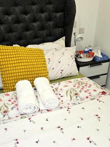 a bed with two pillows and two towels on it at LONDON SLEEPHOUSE in London