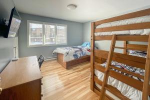 a bedroom with two bunk beds and a desk at Waterville Vacation Condo in Waterville Valley