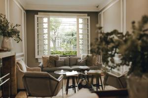 a living room with a couch and a window at Nima Local House Hotel & Spa in Mexico City