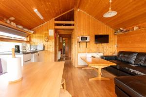 a living room with a couch and a table at Gladheimar Cottages in Blönduós