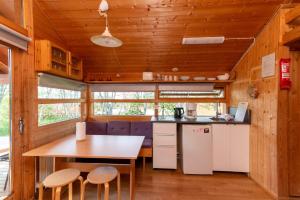 a kitchen with a table and chairs in a tiny house at Gladheimar Cottages in Blönduós
