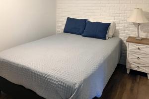 ein Schlafzimmer mit einem Bett mit blauen Kissen und einer Lampe in der Unterkunft Harper Valley 01 in Kimberling City