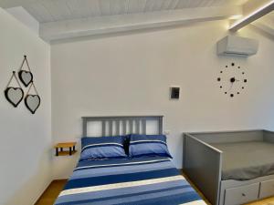 a bedroom with a bed and a clock on the wall at Il Casaletto - Guest House in Terni