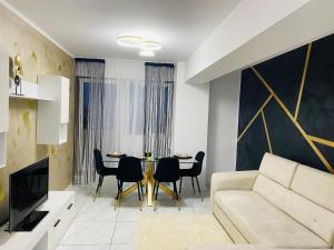 a living room with a couch and a table at Bucharest luxury apartments Bragadiru in Bragadiru