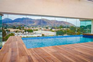 a swimming pool with a view of a city and mountains at hotel vista valle in Tepic