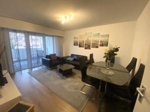 a living room with a table and a couch at Zentrale 4-Zimmer-Wohnung in Sirnach in Sirnach