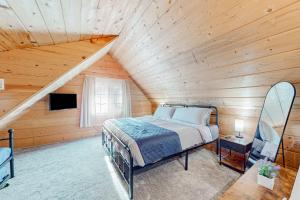 a bedroom with a bed in a wooden attic at Wy'East Rest in Welches