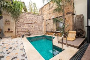 a swimming pool in the middle of a room with a brick wall at Saye Konak Hotel ' Kaleiçi&Oldtown' in Antalya