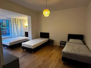 a bedroom with two beds and a chandelier at Rauf und Justyna 2 in Scharmbeck