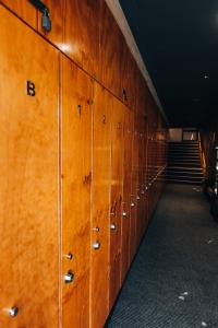 a row of lockers in a hallway with stairs at Falls Creek Hotel in Falls Creek