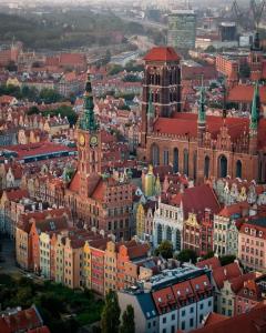 an aerial view of a city with a clock tower at Amber in Gdańsk