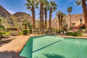 a swimming pool with palm trees and a mountain at Near Golf Indian Wells Studio with Pool Access in Indian Wells