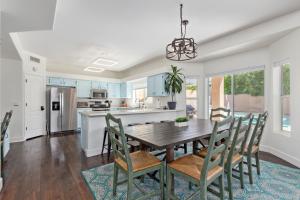 a kitchen and dining room with a wooden table and chairs at Rejuvenate Yourself at this Arizona Home in Scottsdale