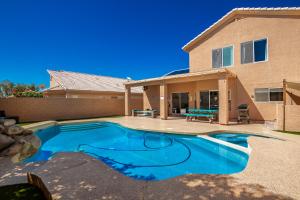 a swimming pool in front of a house at Rejuvenate Yourself at this Arizona Home in Scottsdale