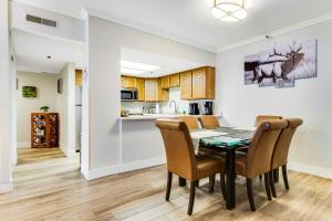 a kitchen and dining room with a table and chairs at Park Station #212 in Park City