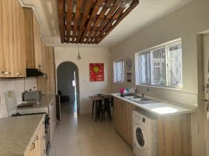 a kitchen with a washer and dryer in it at Peaceful getaway in Cape Town