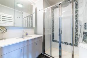 a bathroom with a shower and a sink at Tranquil 3BD Flat w Chic PatioBNFOlympiades in Paris
