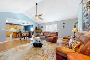 a living room with a couch and a table at Hideaway Haven in Jones Cove