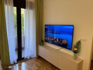 a living room with a flat screen tv on a wall at RS lux Becici in Becici
