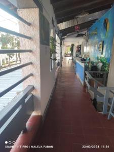 a corridor of a restaurant with tables and benches at HOTEL VISTA AL MAR habitacion para 5 in Rodadero