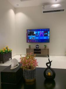 a living room with a flat screen tv on a wall at شقة فاخرة in Al Kharj