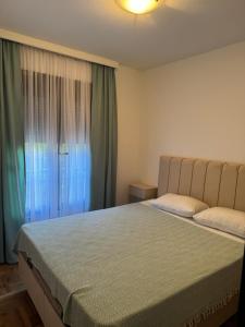 a bedroom with a large bed and a window at RS lux Becici in Becici