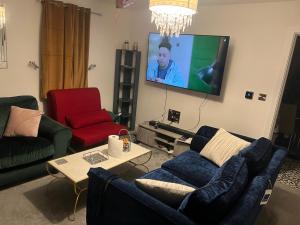 a living room with a couch and a flat screen tv at 119 in Wrockwardine