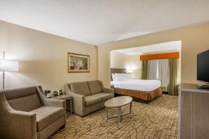 a hotel room with a bed and a couch and chair at Best Western Danville Inn in Danville