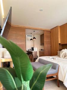 a bedroom with a bed and a living room at Zantamar New cozy beach front apartment in Cruz de Huanacaxtle +22 photos