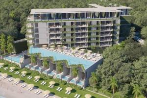 an aerial view of a hotel with a pool and chairs at Zantamar New cozy beach front apartment in Cruz de Huanacaxtle