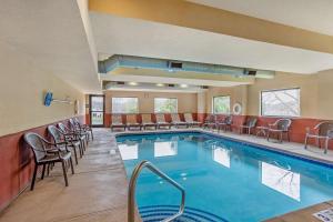 a hotel pool with chairs and tables and chairs at Best Western Danville Inn in Danville
