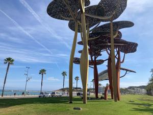 a sculpture of a beach with palm trees and the ocean at Piso centro Salou cerca mar in Salou +3 photos