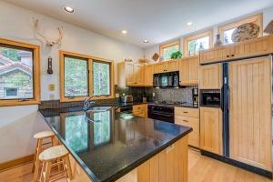 a kitchen with wooden cabinets and a black counter top at Aspen Ridge 32 - 2 bedroom townhouse in Telluride