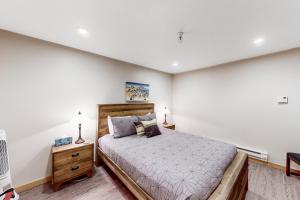 a bedroom with a large bed and a white wall at North #409 in Anchorage