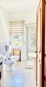 bagno bianco con 2 servizi igienici e doccia di Villa Eagle a Terrasini